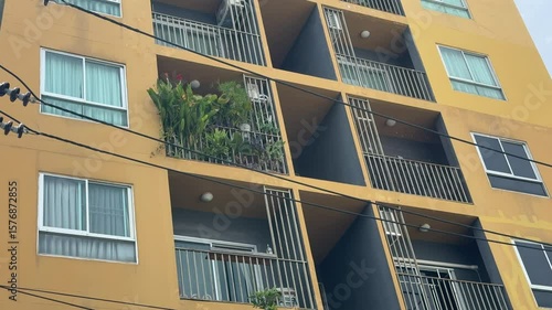 Residential condo windows patio daytime yellow wall.