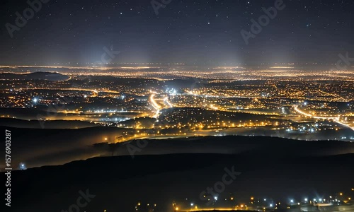 The captivating nocturnal panorama showcases the stunning lights of Paris from a high vantage point, with the urban architecture and bridges illuminated against the twilight sky