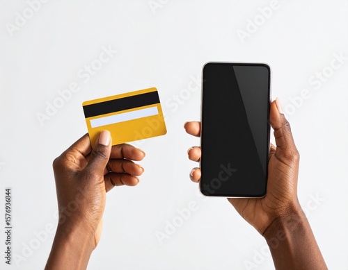 Close-up of hands holding credit card and smartphone, online shopping concept, white background, natural light