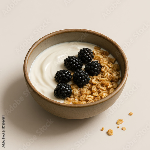 Yogurt with granola and blackberries in bowl