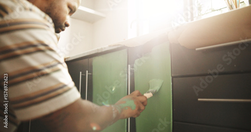 Fototapeta Painting, remodeling and black man in kitchen for DIY project, renovation and creative decoration