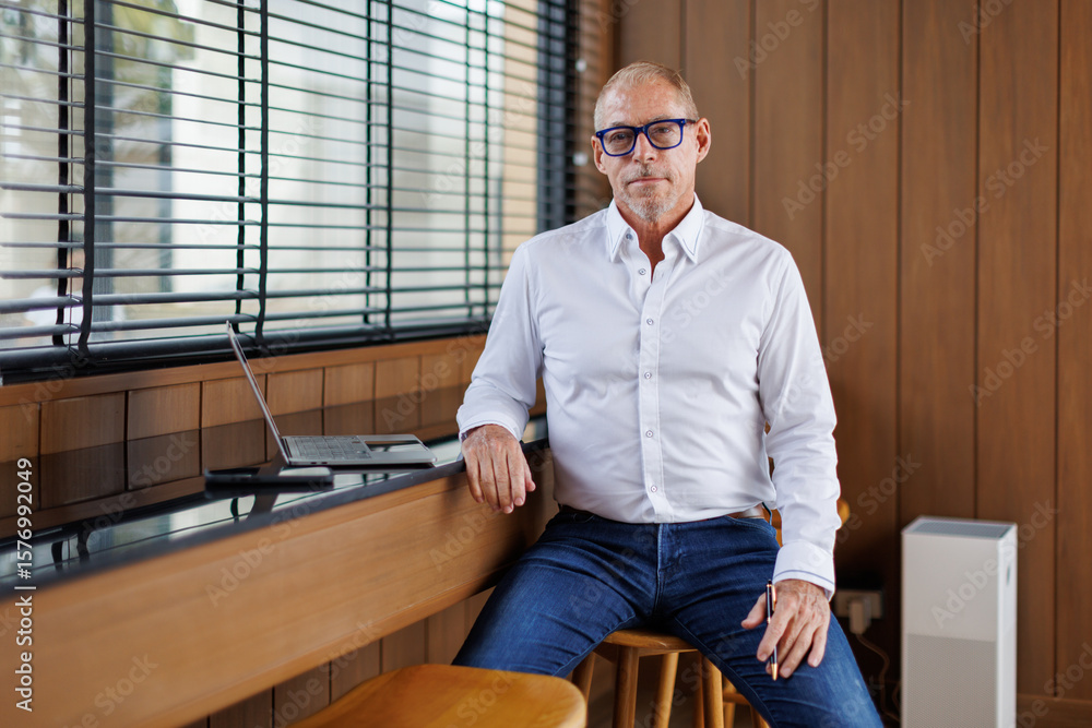 Fototapeta premium Mature business man executive coach talking using laptop computer having video conference call online meeting, professional training negotiation remote working doing online presentation in office. 