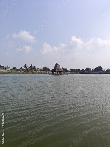 A spiritually resonant view of Thirukazhukundram, Tamil Nadu, India, capturing both the hilltop Vedagiriswarar Temple and the ancient foothill temple complex. The hill temple, dedicated to Lord Shiva,