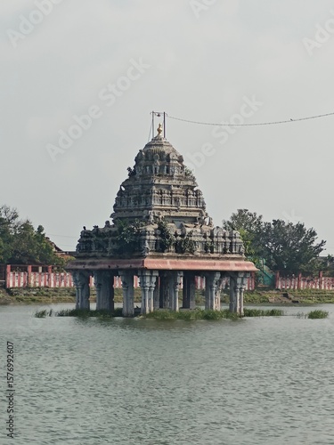 A spiritually resonant view of Thirukazhukundram, Tamil Nadu, India, capturing both the hilltop Vedagiriswarar Temple and the ancient foothill temple complex. The hill temple, dedicated to Lord Shiva,