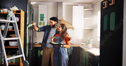 Diy, painting and renovation with couple in kitchen of apartment together for home improvement. Maintenance, paintbrush and smile with happy people in new house for remodeling, repairs or restoration