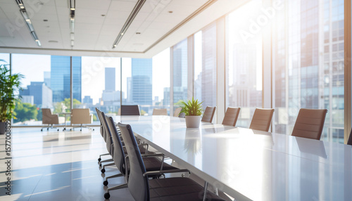 Close-up of an empty meeting table with no one in the background of a blurry company meeting room.