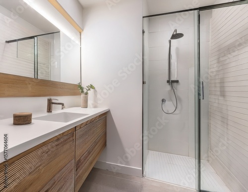 Minimalist white bathroom with hidden storage, vessel sink, frameless mirror, and floor-level walk-in shower