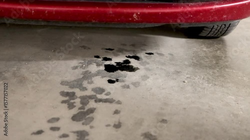 Motor Oil Leak Under a Car on a Garage Floor