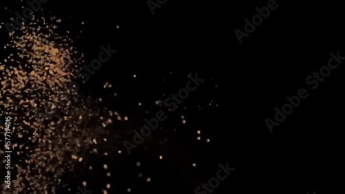 Golden brown sand particles burst and swirl in slow motion against black background, dynamic dust cloud explosion animation, textured powder effect 5 sec loop
