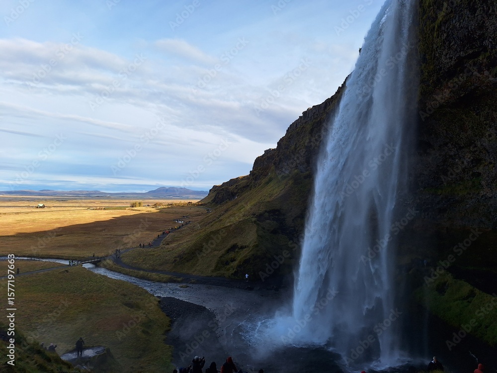 Fototapeta premium Seljalandsfoss is unique—you can walk behind it. Nearby, Gljúfrabúi is hidden in a canyon, offering a secret, misty experience