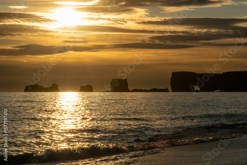 Reynisfjara is Iceland’s famous black sand beach with basalt columns, crashing Atlantic waves, and dramatic sea stacks.