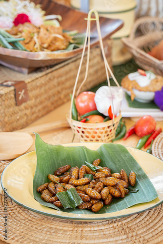 Fried insects -  Express worms or fried bamboo worms insect crispy with pandan after fried and add a light coating of sauce and garnish Thai pepper powder
