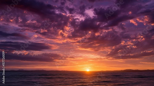 Vibrant Sunset Over the Ocean with Dramatic Clouds and Colorful Reflections in the Water