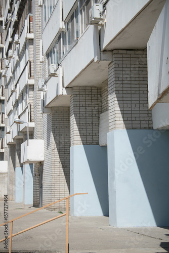 large brick blue plastered concrete arches on the ground floor of an apartment building