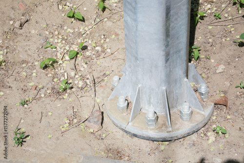  support of a metal lamppost reinforced with large iron screws