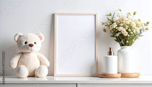 Cozy nursery scene featuring a blank frame, teddy bear and floral arrangement
