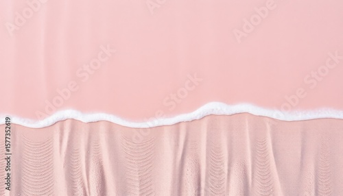 Pink beach abstract with waves and textured sand from top view