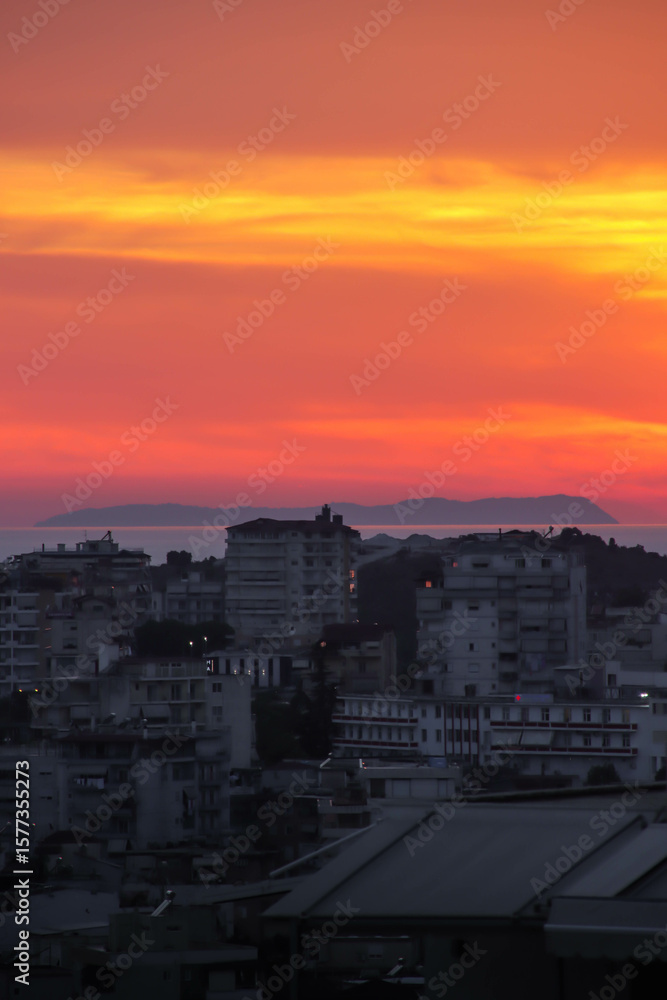 Golden sunset over a seaside city, with calm water reflecting the colorful sky.
Golden sunset over a seaside city, with calm water reflecting the colorful sky.