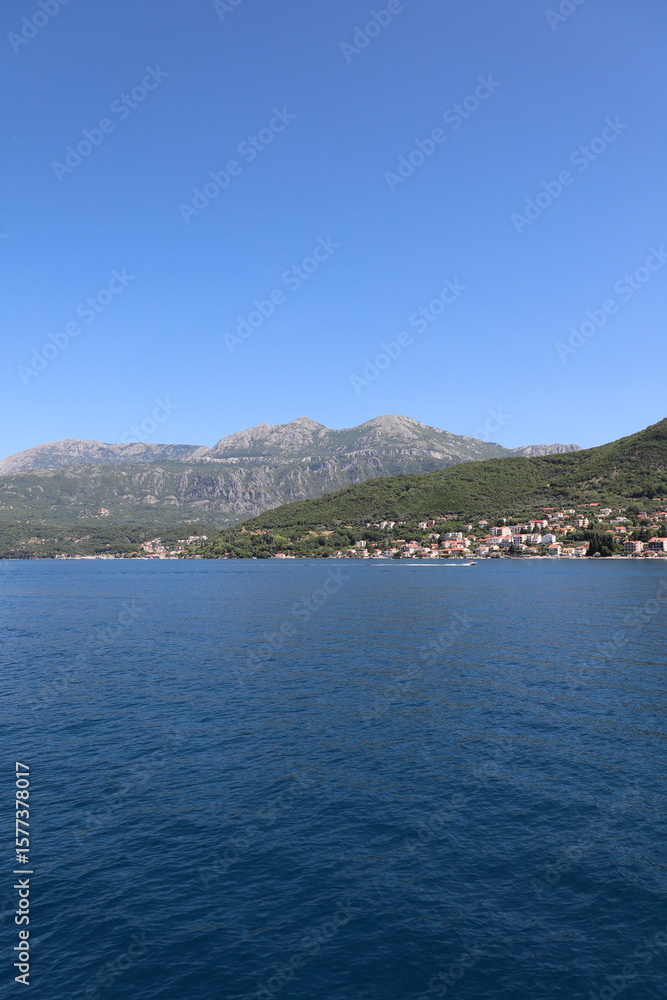 Fototapeta premium mountain fishing village in the fjords of Montenegro. Bay of Kotor. Vertical photo