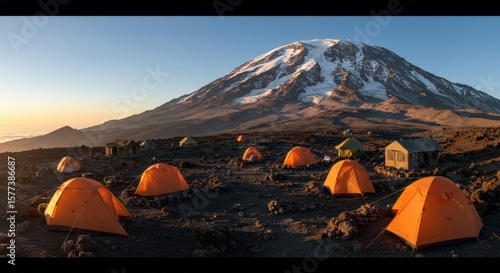 Colorful tents set up at a base camp beneath Mount Kilimanjaro, Tanzania. High-altitude camping experience on Africa’s tallest mountain, surrounded by dramatic landscapes.