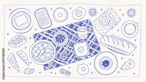Overhead view of a breakfast spread with pastries eggs and fruit on a checkered tablecloth design