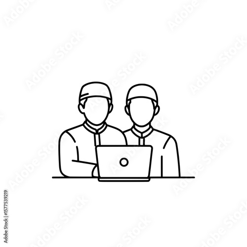 Two workers in uniforms using a laptop at work station