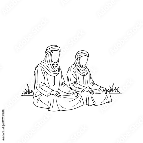 Two women wearing traditional head coverings sitting on grass