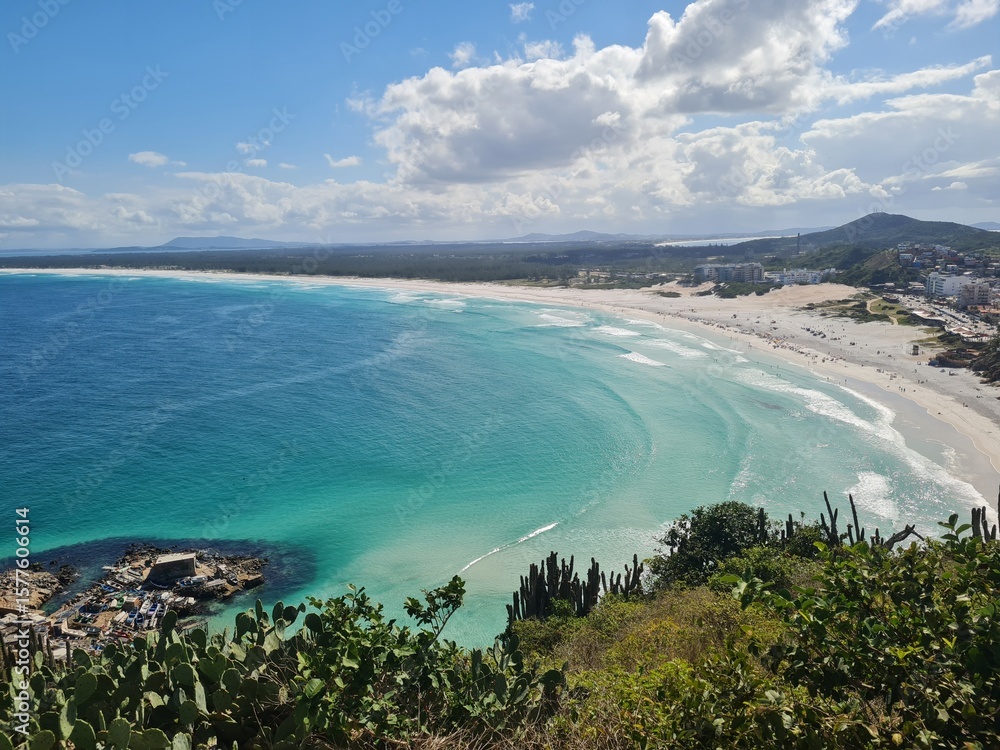 Fototapeta premium Praia Grande (Big Beach) Arraial do Cabo, Rio de Janeiro - Brazil: sunny morning, coastal atmosphere of the winter, white sand and crystal-clear blue waters in Brazilian Caribbean.