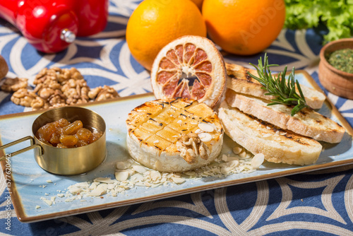brie, with a golden, caramelized top and scattered almond slices and walnut pieces