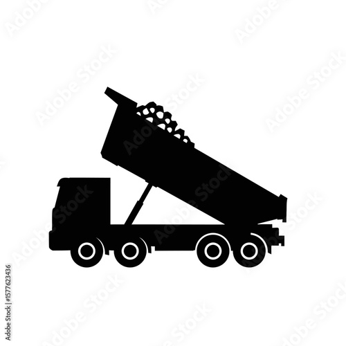 A stark black silhouette of a heavy-duty dump truck is depicted actively unloading a pile of gravel or construction material.