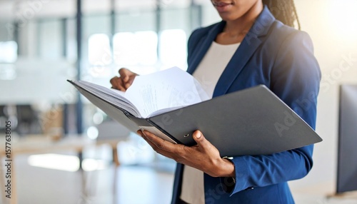 Serious courtroom lawyer preparing litigation documents for a business client before an official hearing, formal suit, seated at a polished wooden desk with open legal files and case notes, classic la