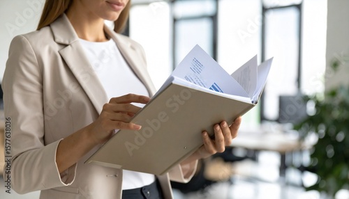 Serious courtroom lawyer preparing litigation documents for a business client before an official hearing, formal suit, seated at a polished wooden desk with open legal files and case notes, classic la