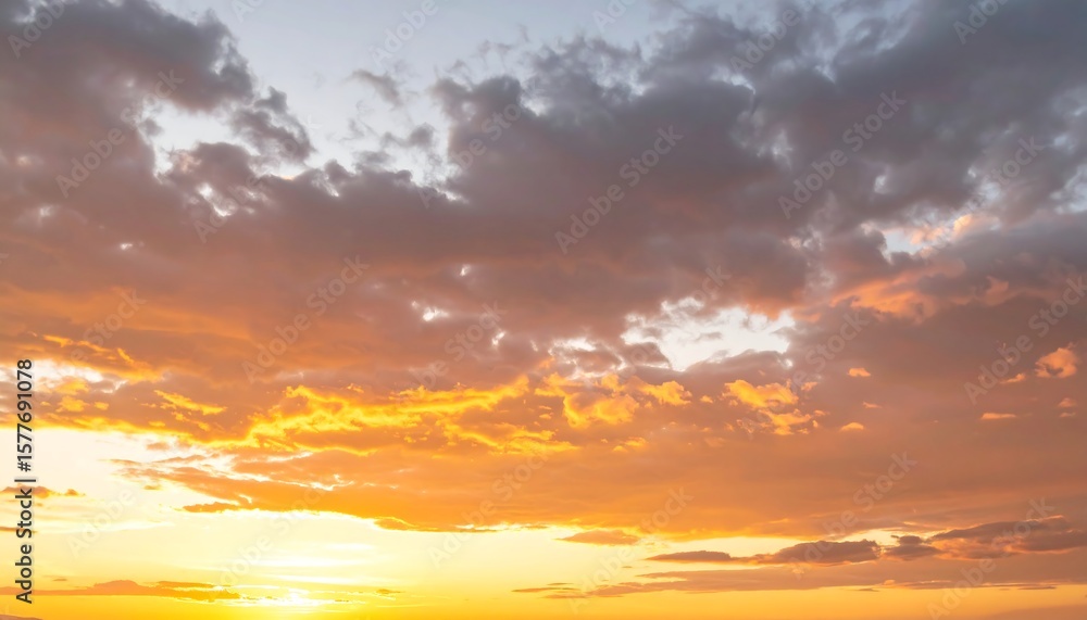 Fototapeta premium A golden sunset sky filled with clouds