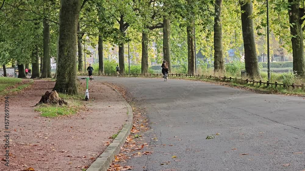 Lille, France - 15 October 2024 - People walking and jogging on the path in Parc de la Citadelle, Lille