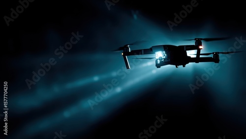 Drone Silhouetted drone flies in the dark, emitting bright beams, against blue night