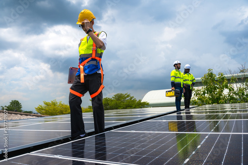Slika na platnu Group of photovoltaic engineer men working together inspecting solar panels on b