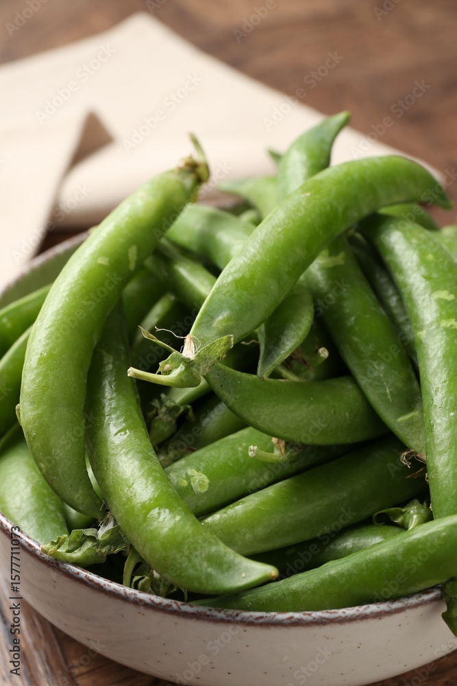 Fresh ripe green peas on wooden table, closeup Fresh ripe green peas on wooden table, closeup
