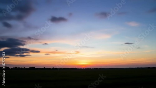 Wallpaper Mural Dramatic Sunset Over Fields With Colorful Clouds And Golden Horizon Torontodigital.ca
