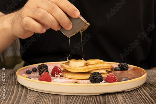 Delicious pancake breakfast served with fresh berries and syrup