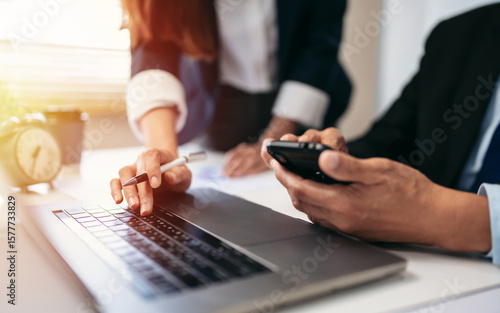 Wallpaper Mural Two people are looking at a laptop and cell phones Torontodigital.ca