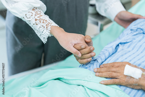 Terminally ill patients and their relatives in a hospital room. Sick patient lying on bed in hospital.