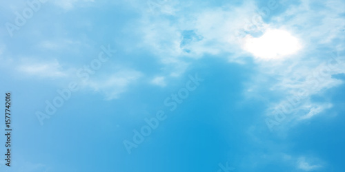 Blue sky, sun, clouds. A peaceful moment with underlying complexity. A reflection of the sky on thin clouds. Hidden emotions beneath a bright exterior like feeling melancholic on a good day background