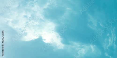 Blue sky, sun, clouds. A peaceful moment with underlying complexity. A reflection of the sky on thin clouds. Hidden emotions beneath a bright exterior like feeling melancholic on a good day background
