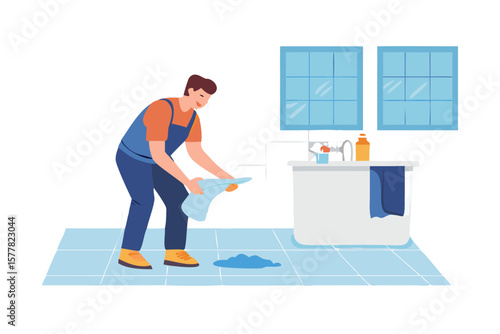 Man in overalls cleaning up a spill in a bathroom with a towel