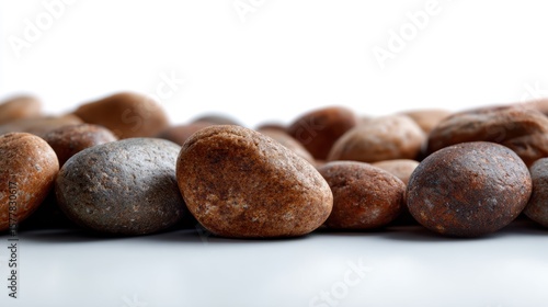 Wallpaper Mural A neatly arranged row of small, smooth brown river stones, isolated on a pure white background. Earthy, natural texture. Torontodigital.ca