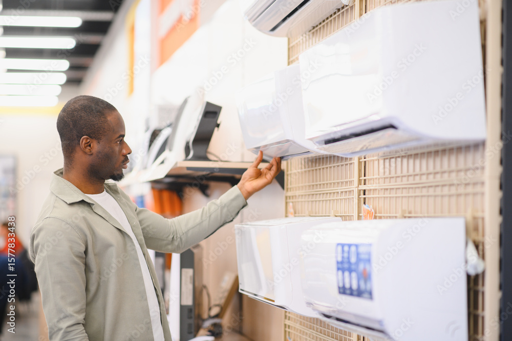 Customer choosing air conditioner in electronics store Customer choosing air conditioner in electronics store