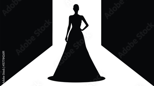 A striking silhouette of a woman in a flowing gown on a brightly lit runway
