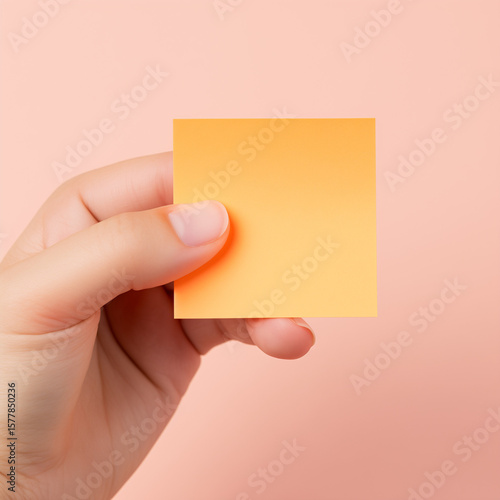 hand holding a blank note pad