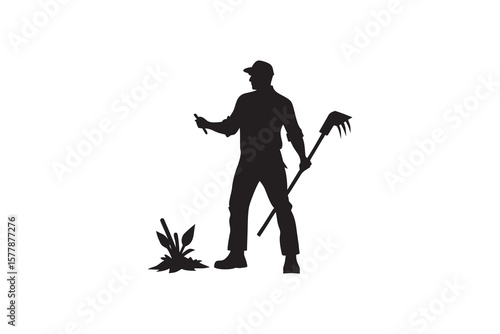 Silhouette of a Farmer Working in a Field with a Hand Tool