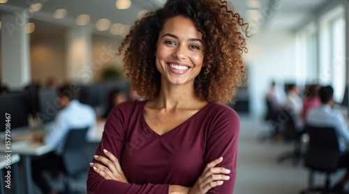 Confident and Smiling Young African American Businesswoman Standing in a Modern Office Environment.